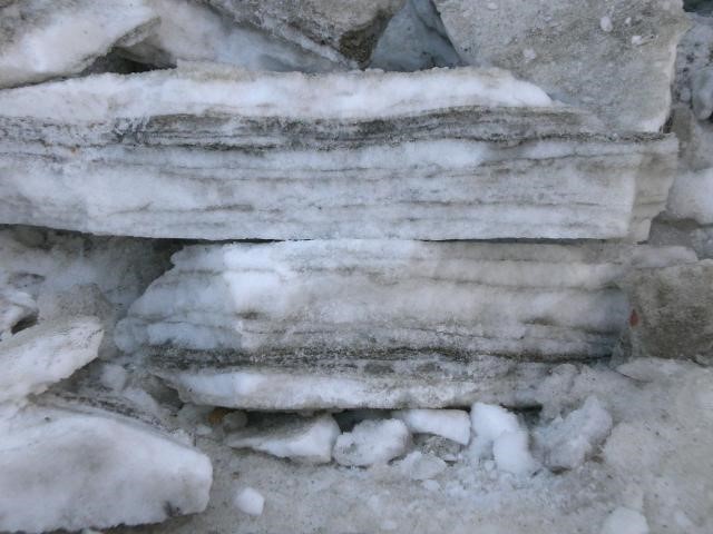 Snow/ice plates from the streets. Like with tree rings you can count the number of times when snow was falling by the dirt layers.